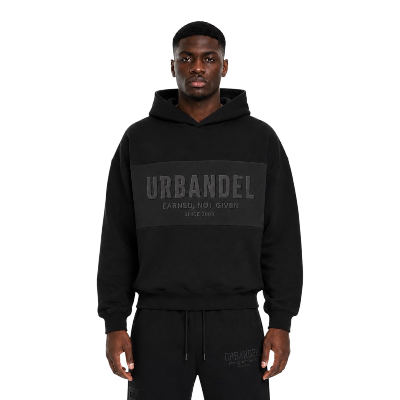 URBANDEL Midnight Crest Hoodie in Black featuring premium 400 GSM heavyweight fleece, oversized fit, tonal raised chest and back logos, and signature Earned. Not Given. Since 2008. branding.