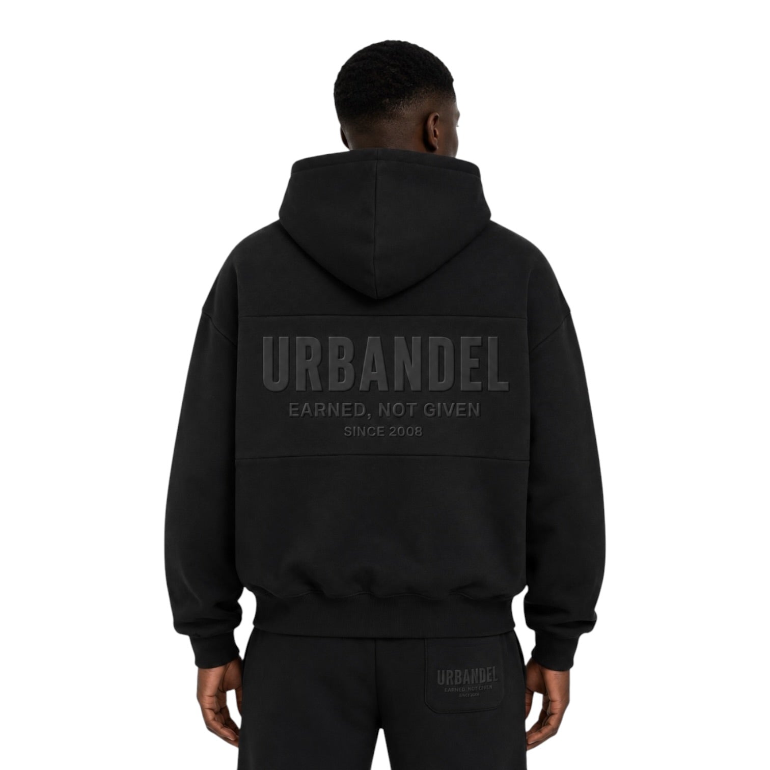 URBANDEL Midnight Crest Hoodie in Black featuring premium 400 GSM heavyweight fleece, oversized fit, tonal raised chest and back logos, and signature Earned. Not Given. Since 2008. branding.