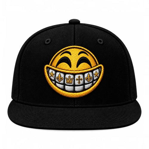 A black flat-brim baseball cap featuring a large embroidered yellow smiley face with gold grillz on a white background.